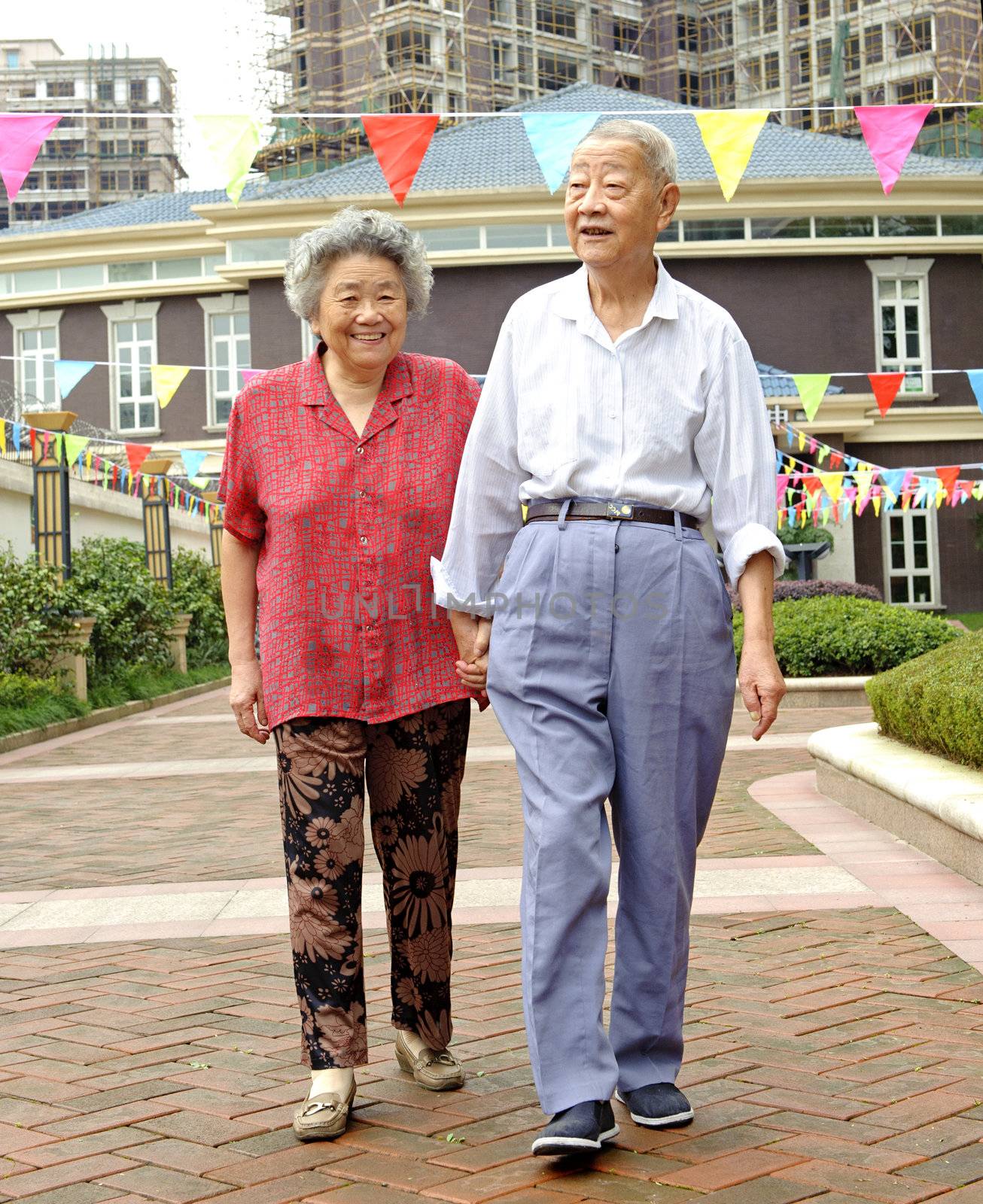 an intimate senior couple are walking