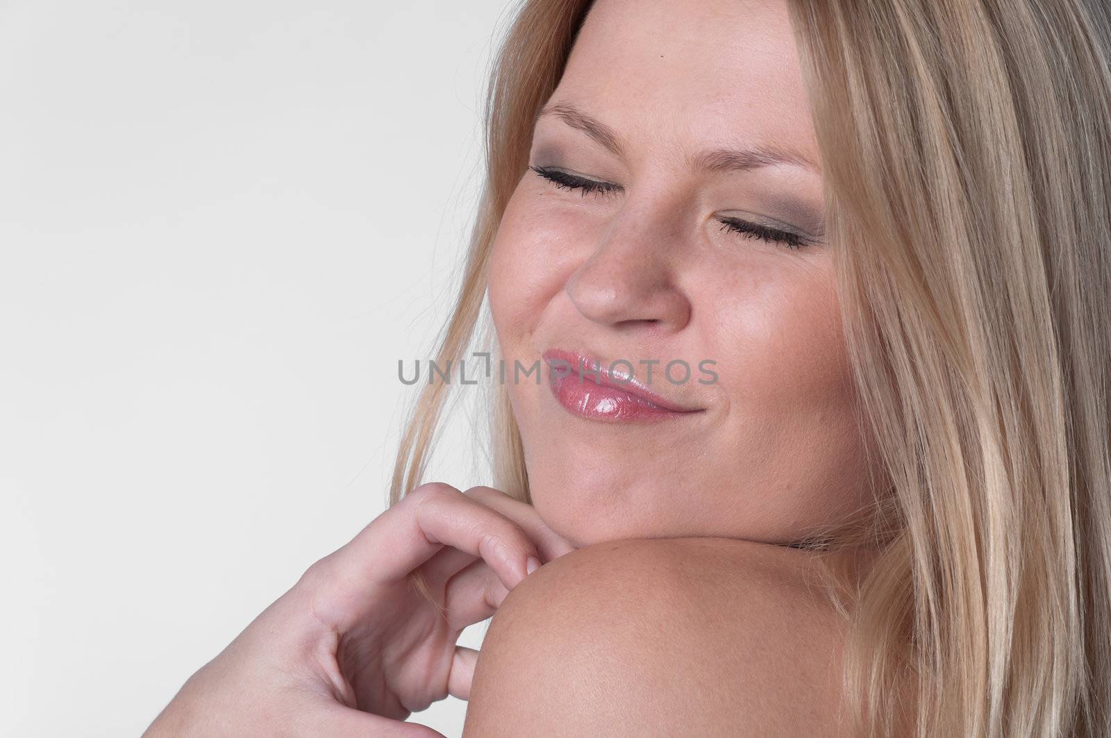 Portrait of the young and beautiful girl with naked shoulders