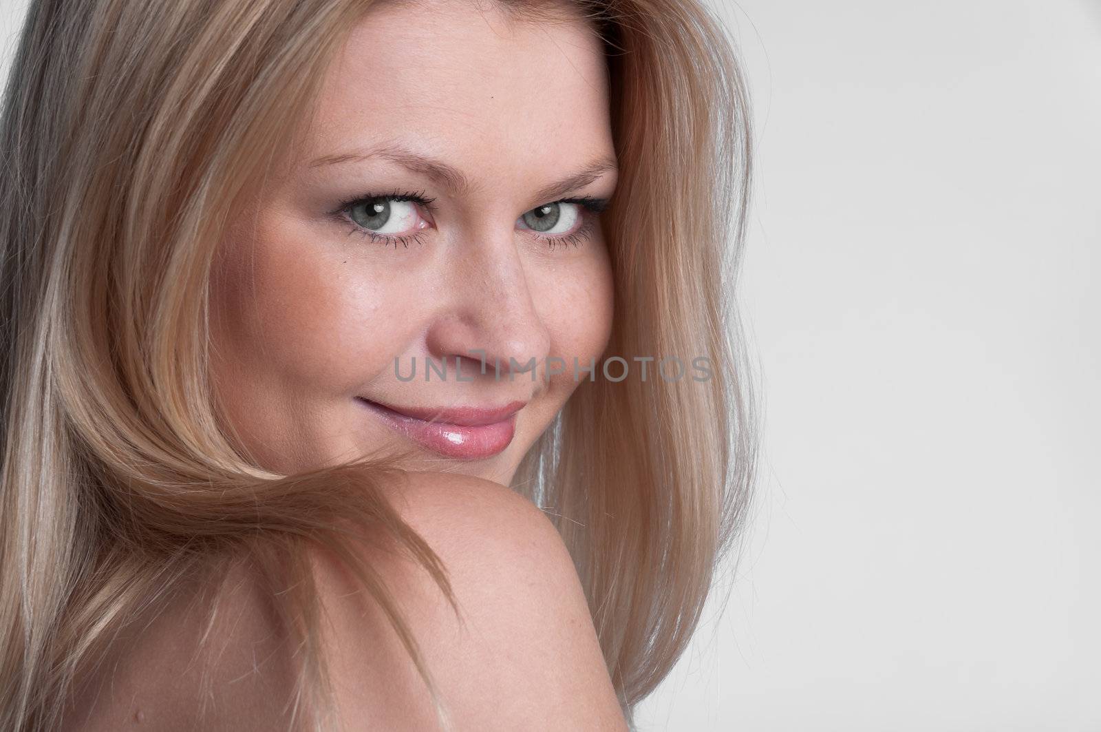 Portrait of the young and beautiful girl with naked shoulders