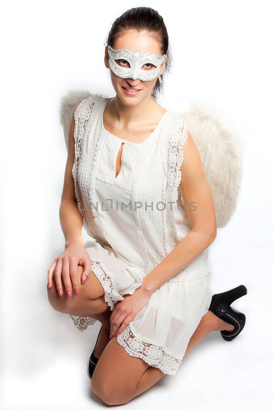 Young and beautiful girl in the mask and costume of an angel
