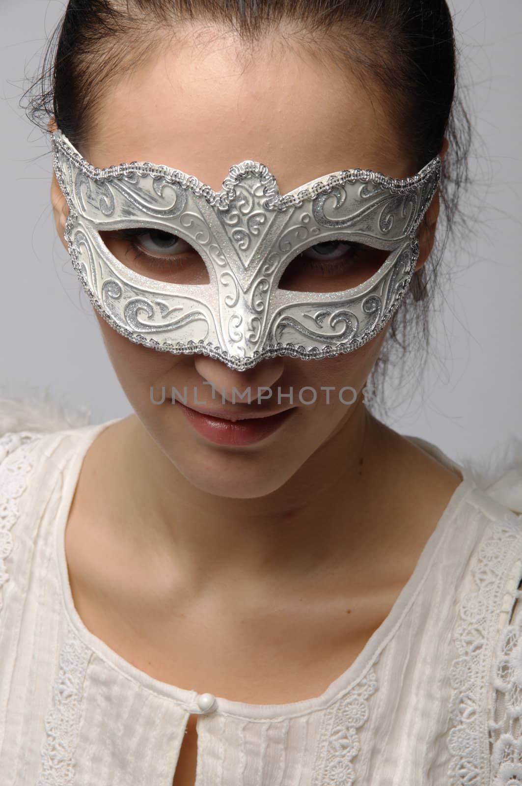 Young and beautiful girl in the mask and costume of an angel