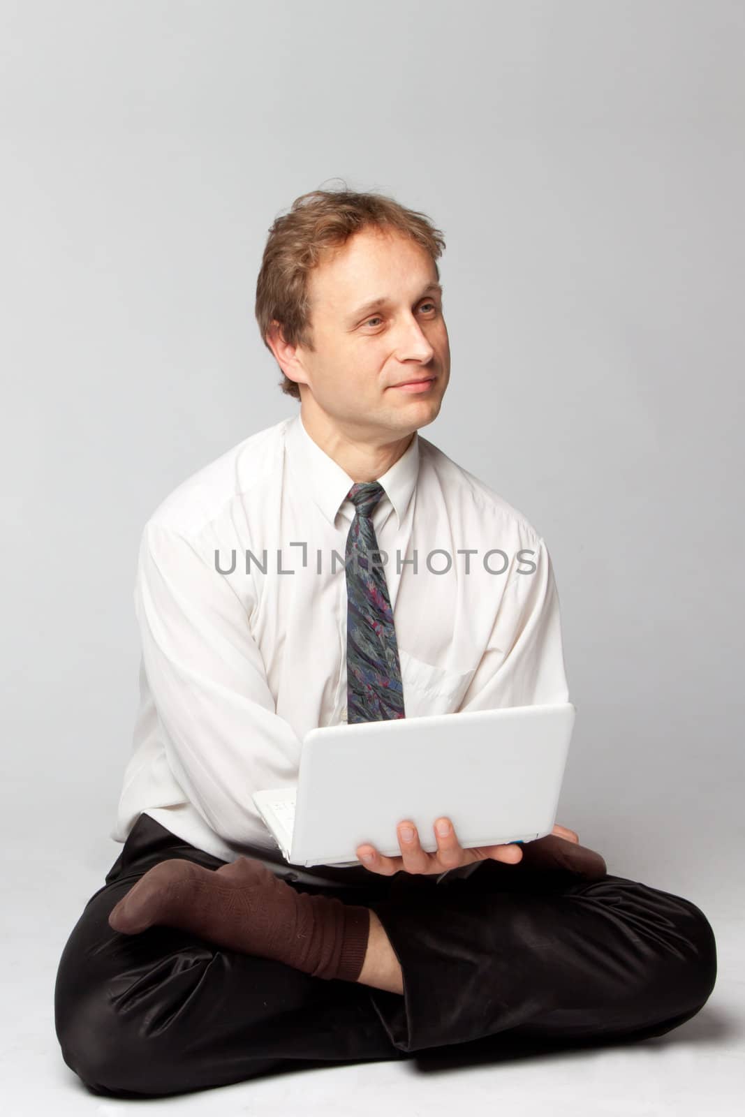 Young businessman yoga before an open notebook
