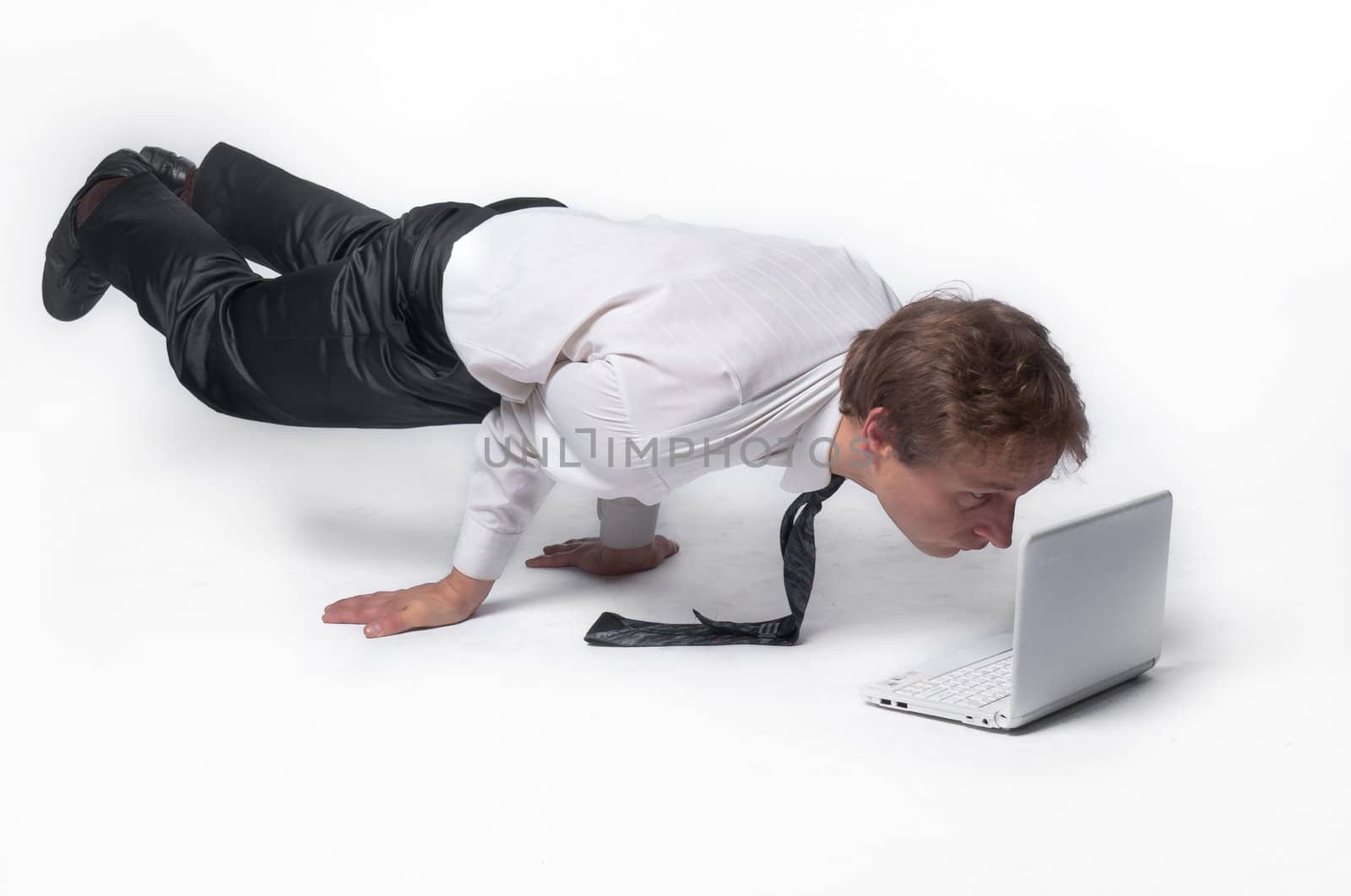 Young businessman yoga before an open notebook