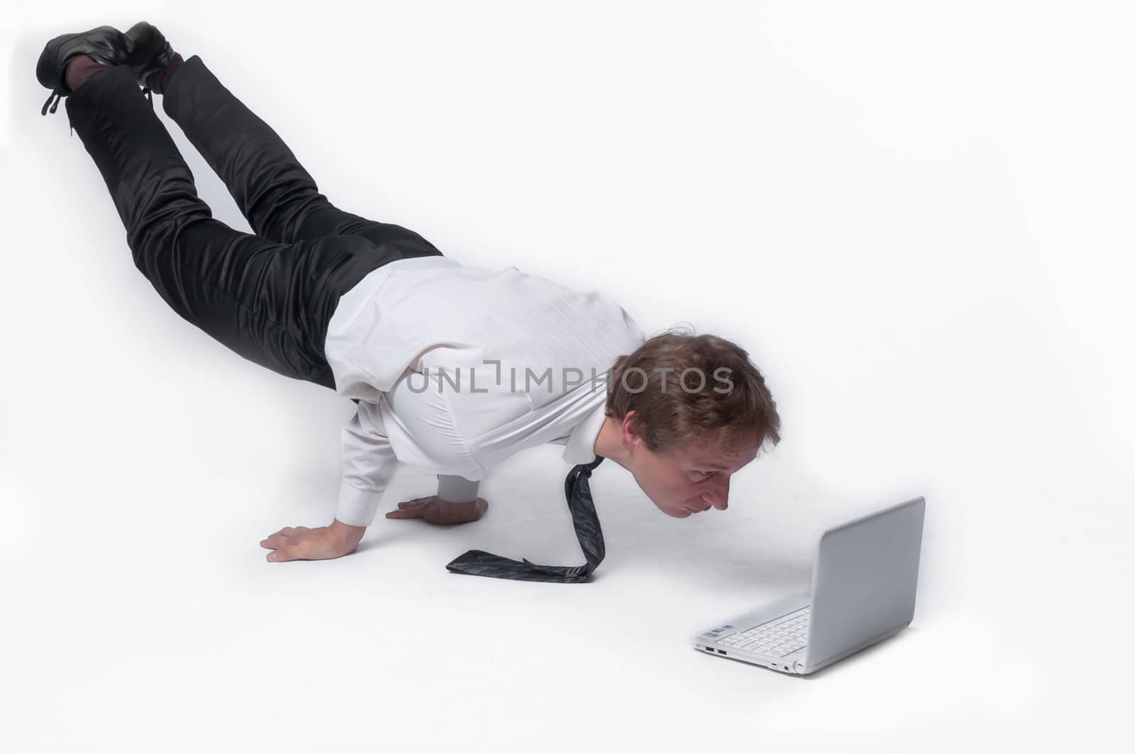 Young businessman yoga before an open notebook