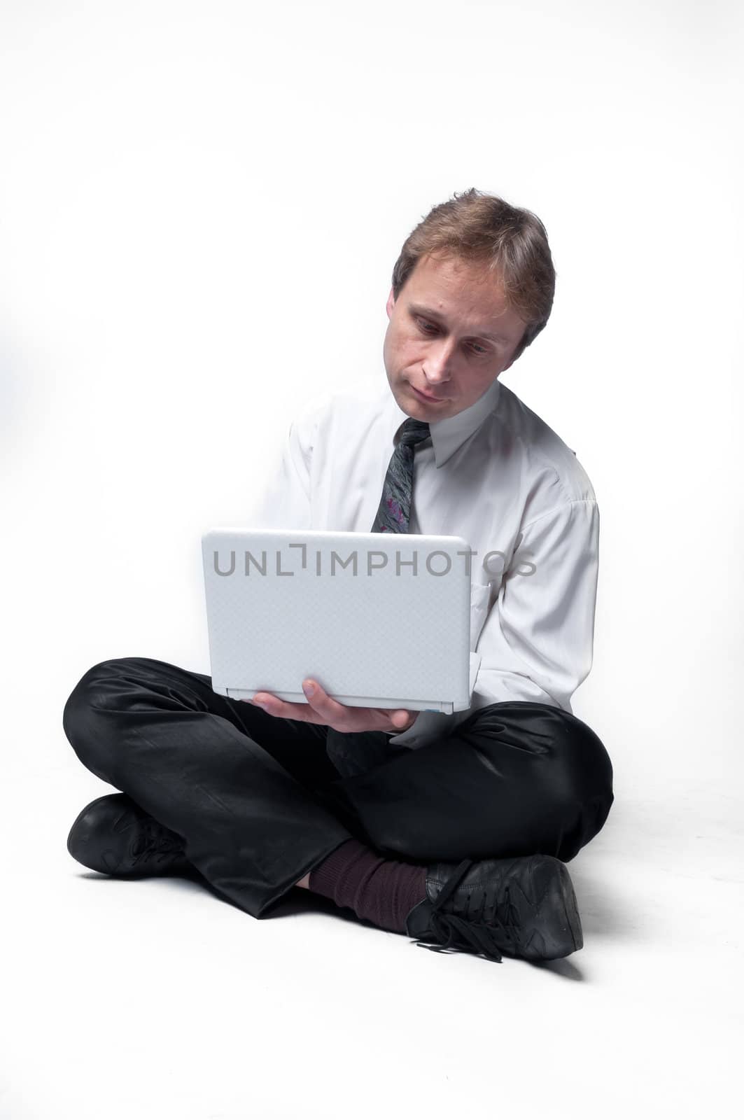 Young businessman yoga before an open notebook