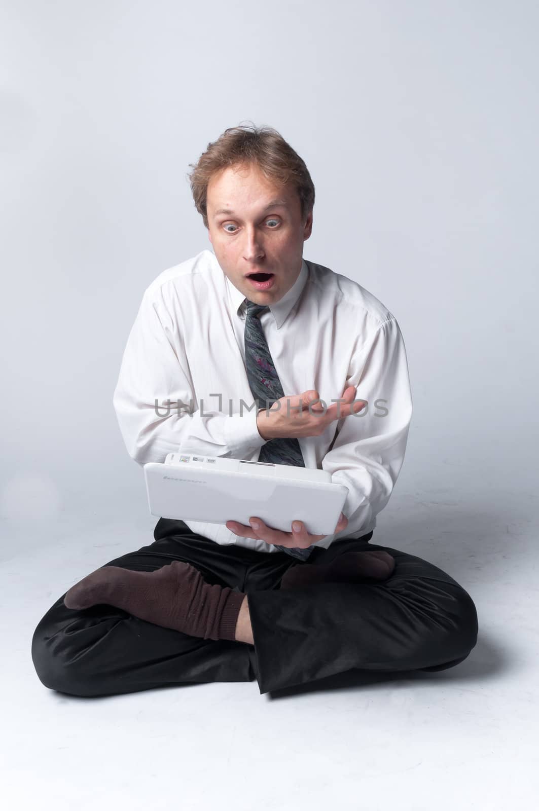 Young businessman yoga before an open notebook