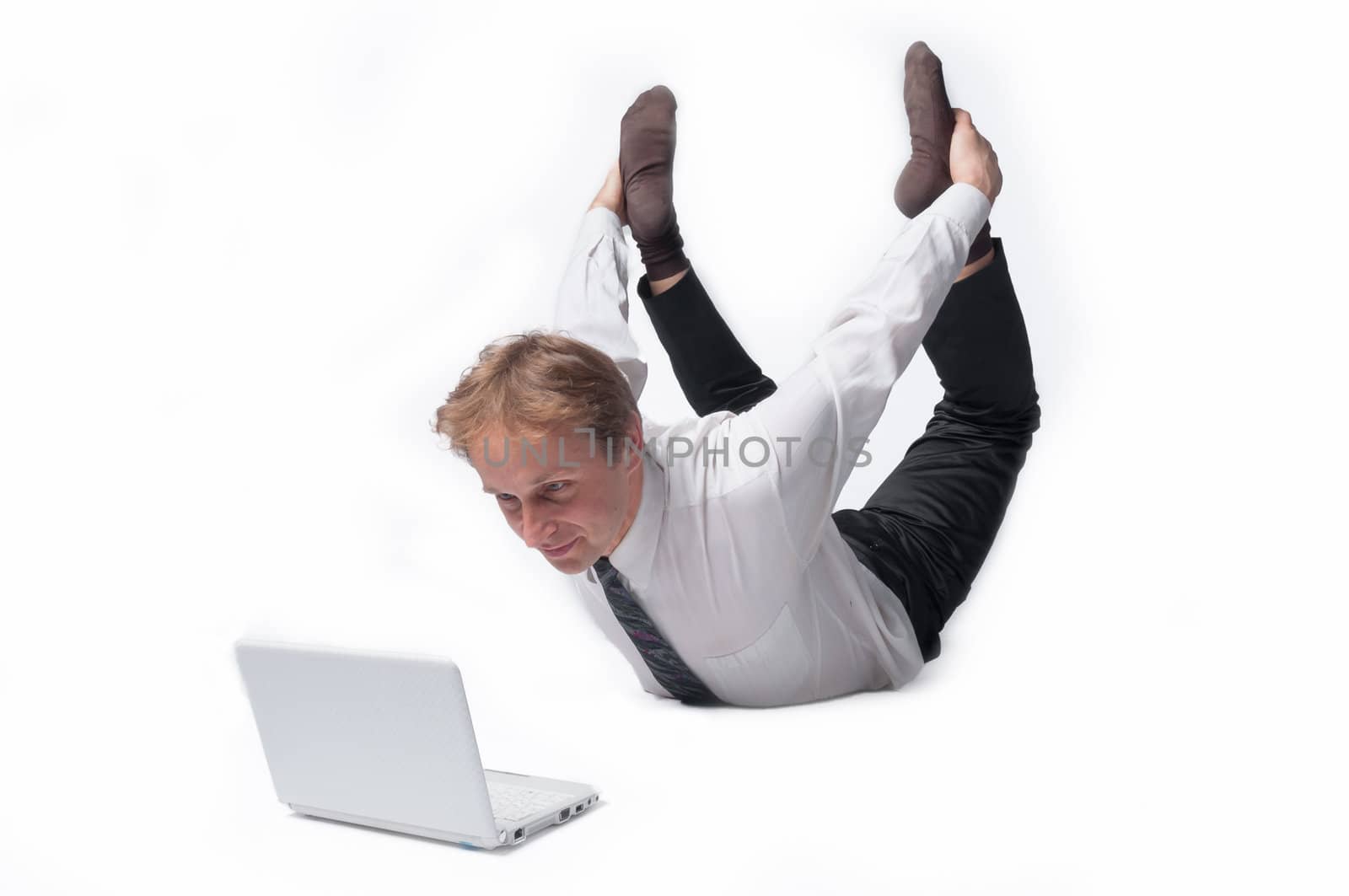 Young businessman yoga before an open notebook