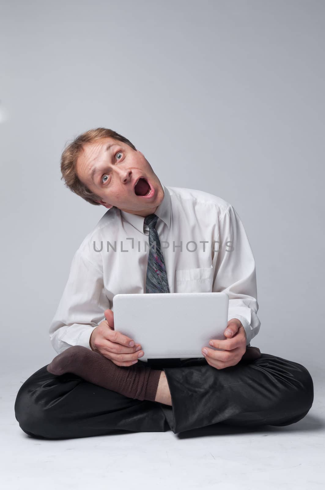 Young businessman yoga before an open notebook