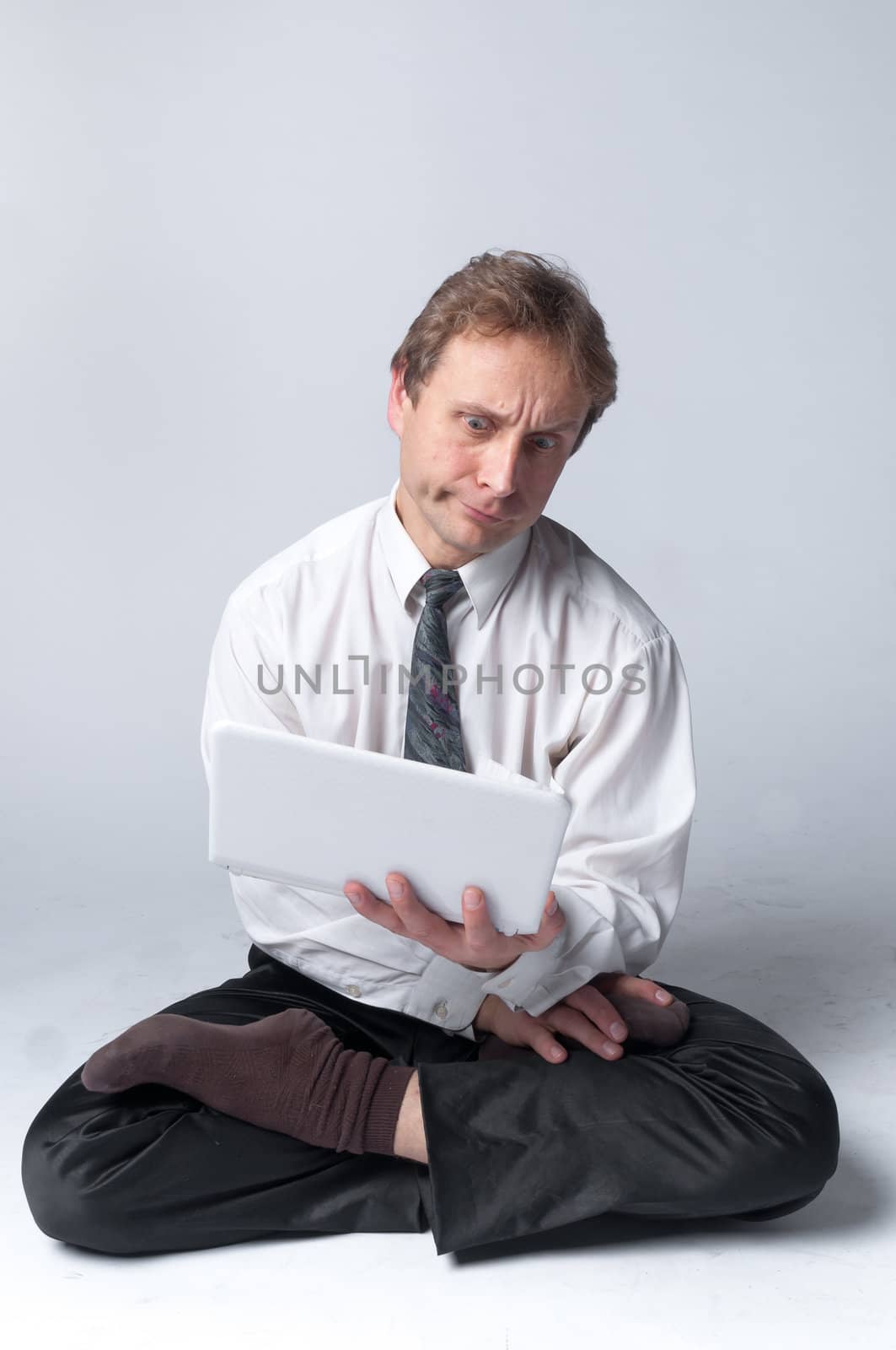 Young businessman yoga before an open notebook