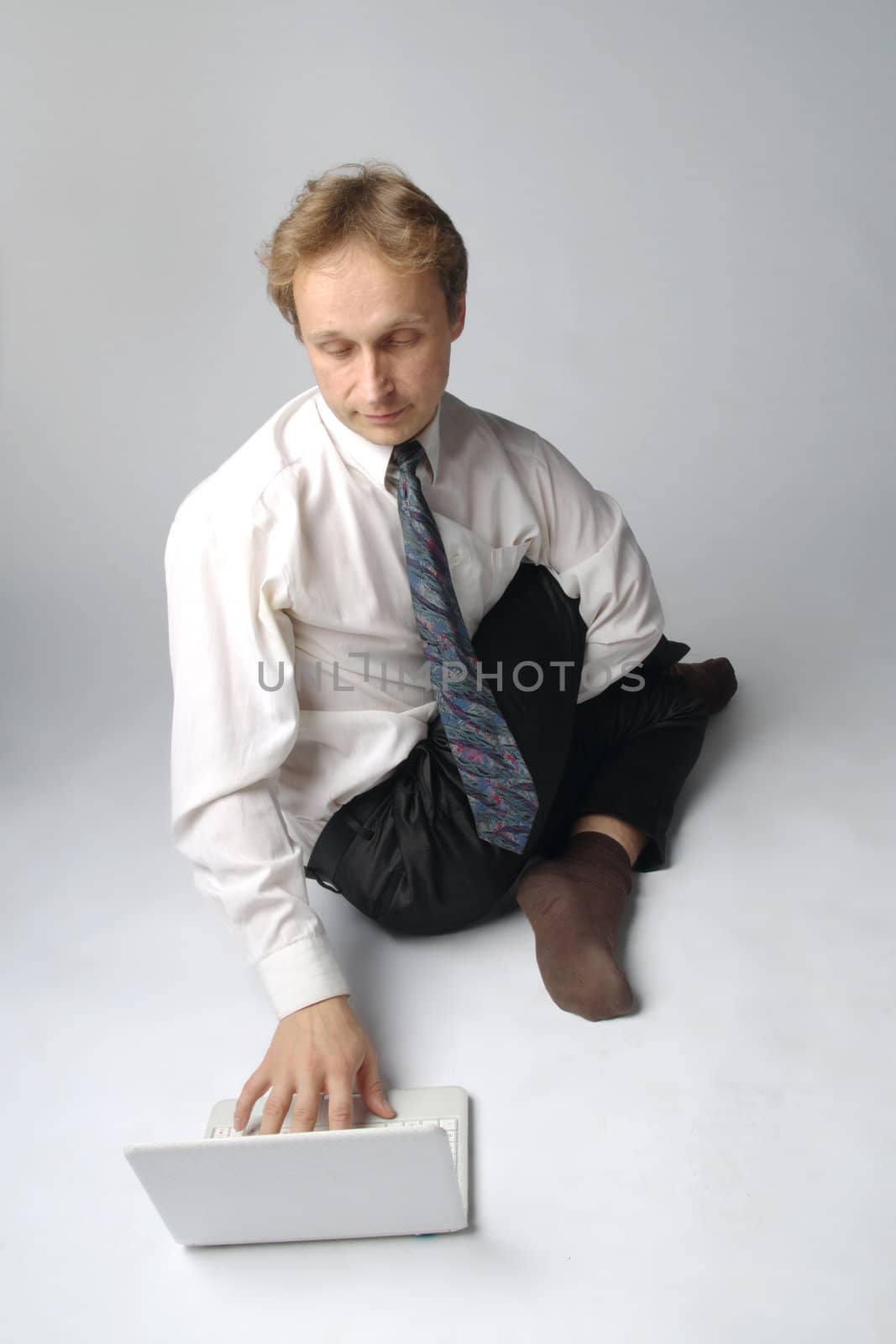 Young businessman yoga before an open notebook