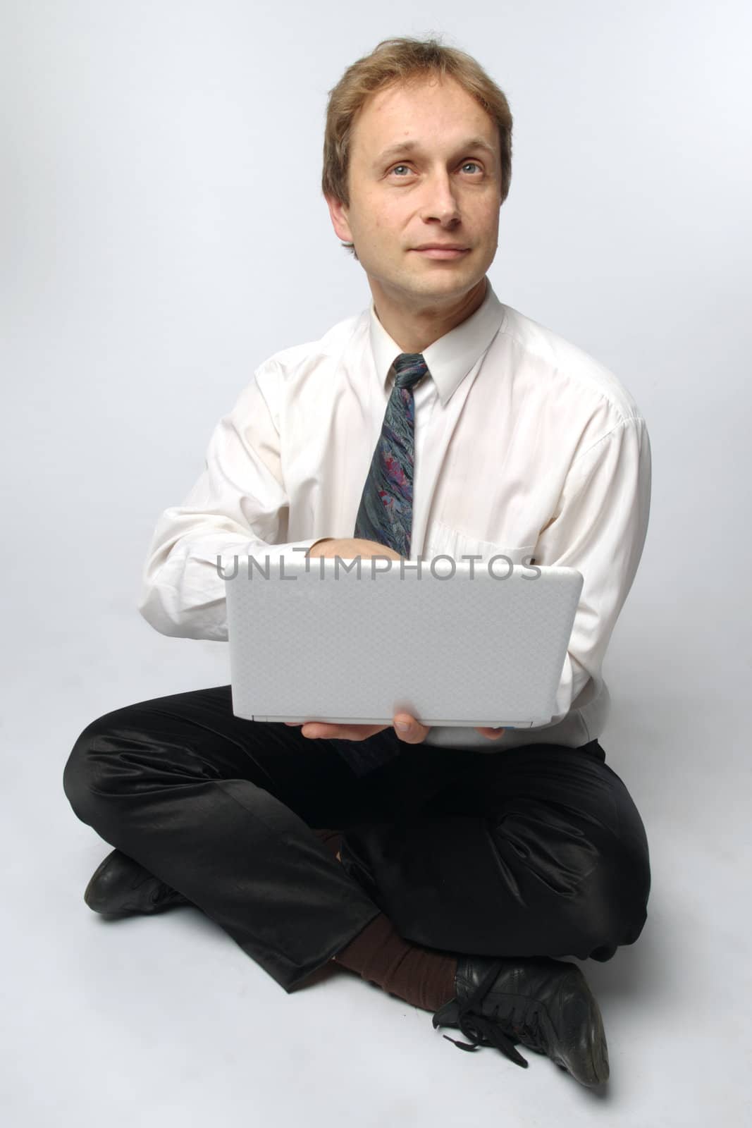 Young businessman yoga before an open notebook