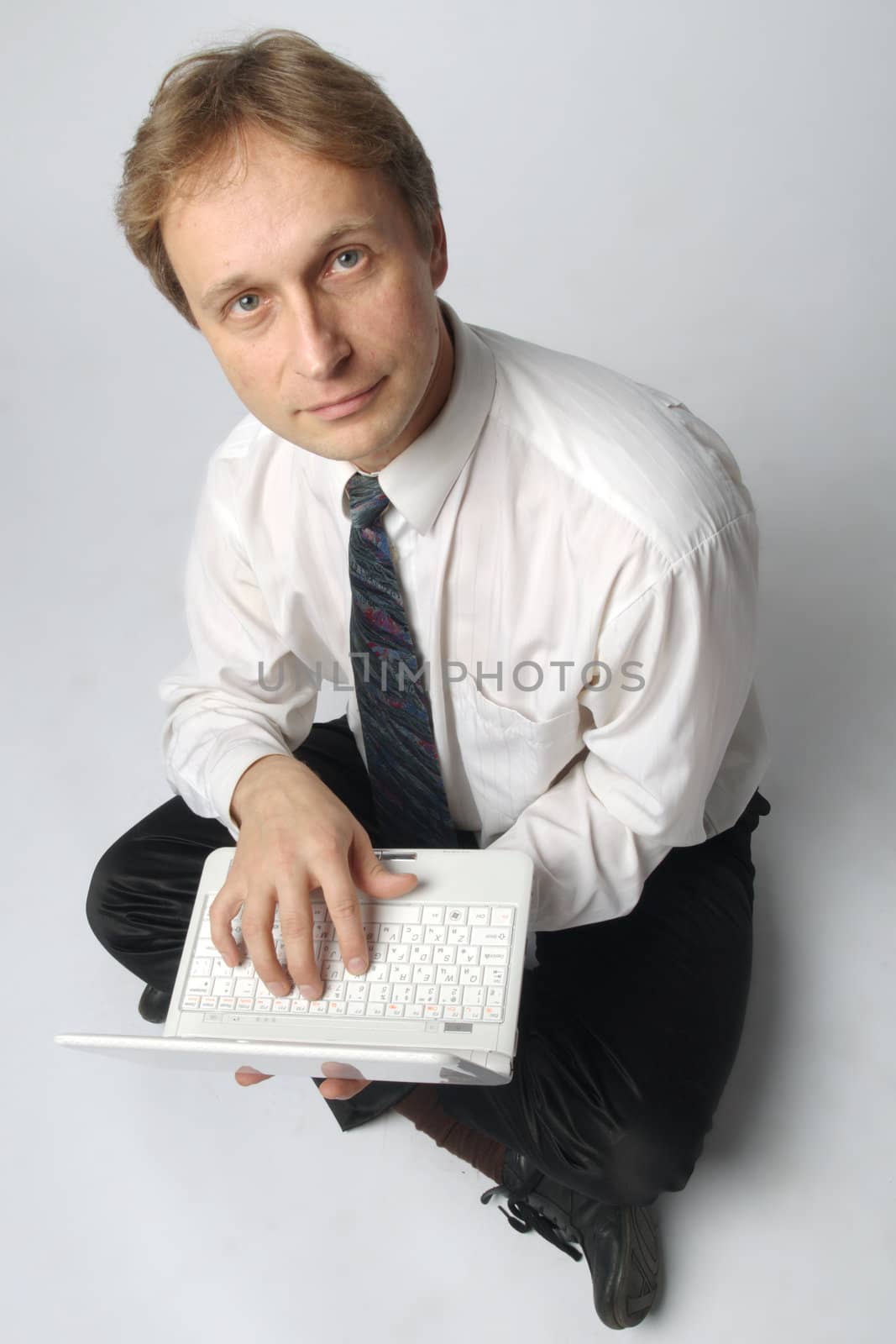 Young businessman yoga before an open notebook
