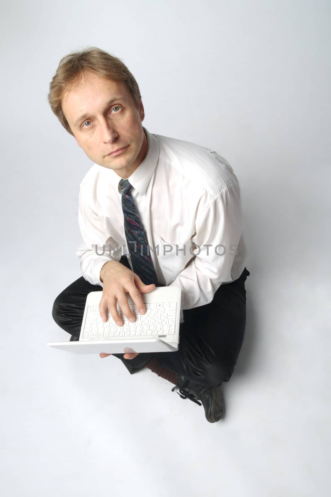 Young businessman yoga before an open notebook