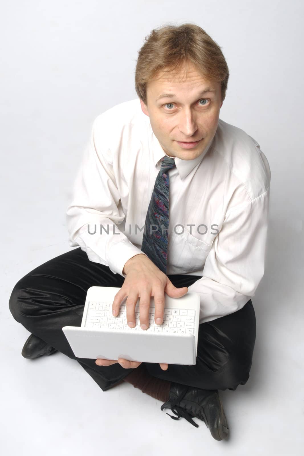 Young businessman yoga before an open notebook