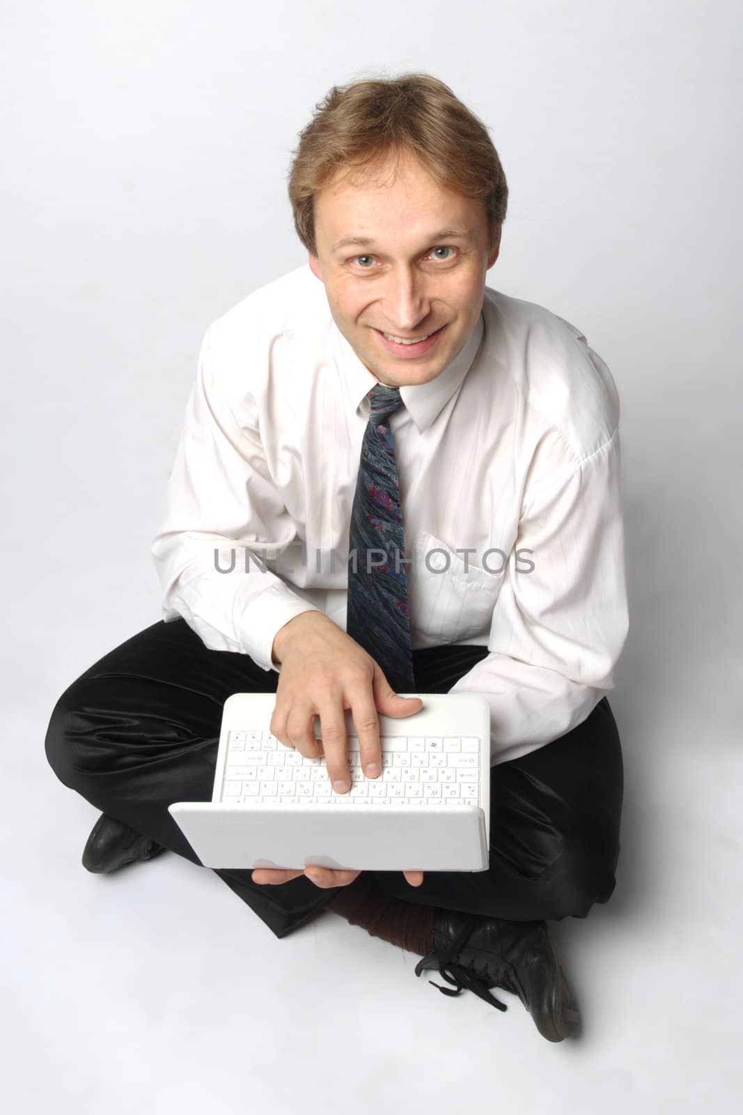 Young businessman yoga before an open notebook