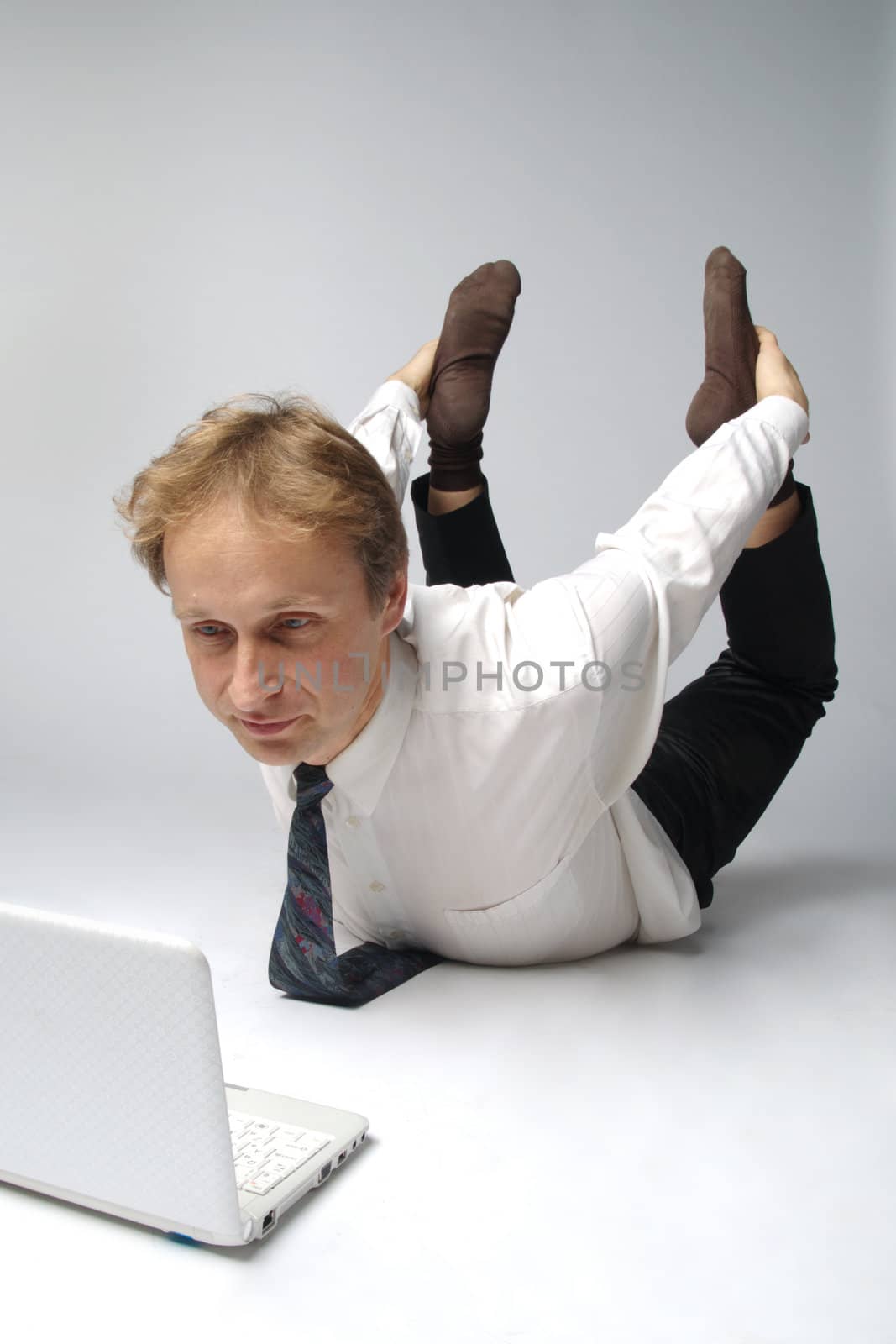 Young businessman yoga before an open notebook