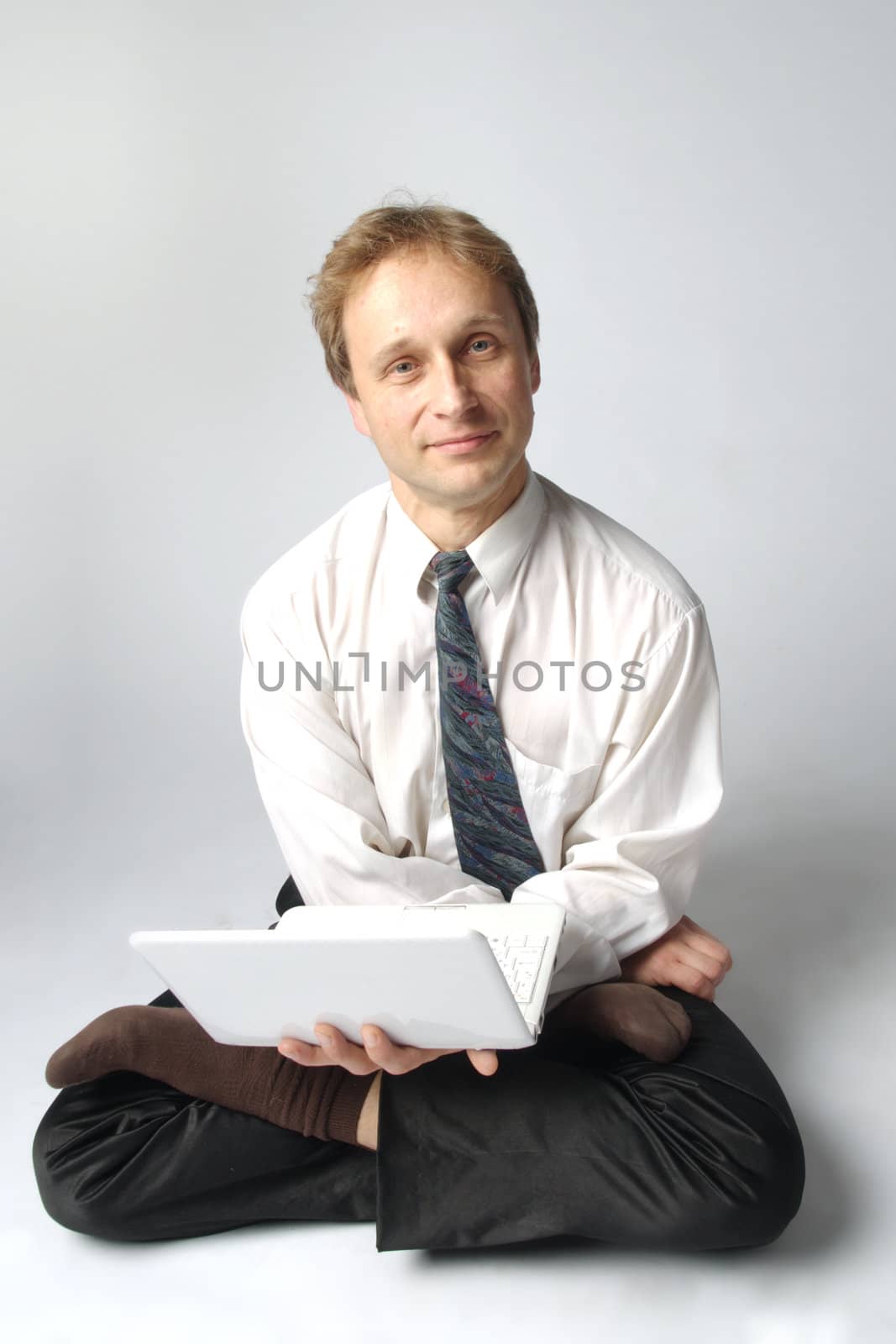 Young businessman yoga before an open notebook