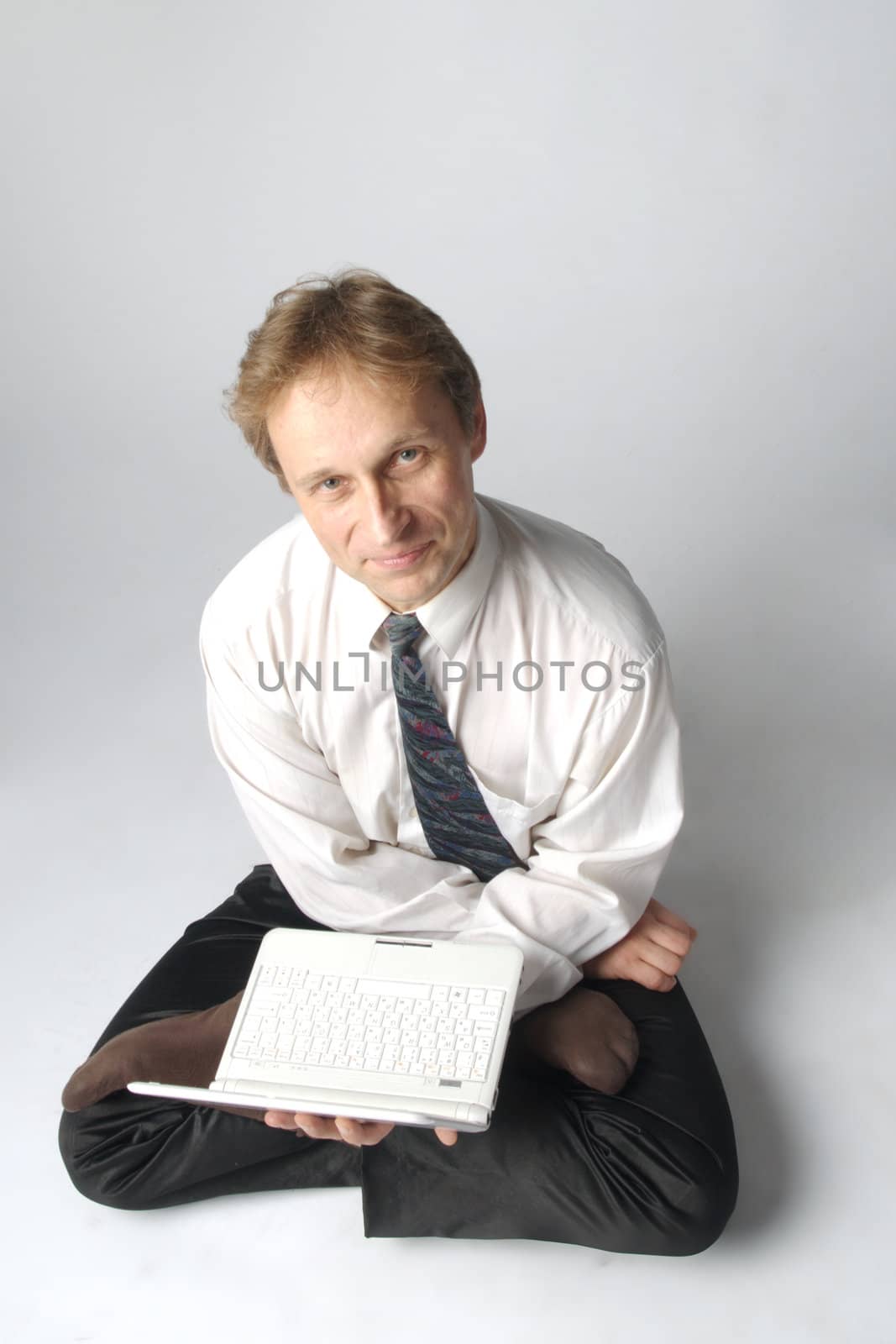 Young businessman yoga before an open notebook