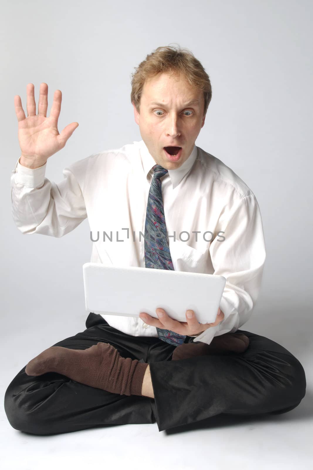Young businessman yoga before an open notebook
