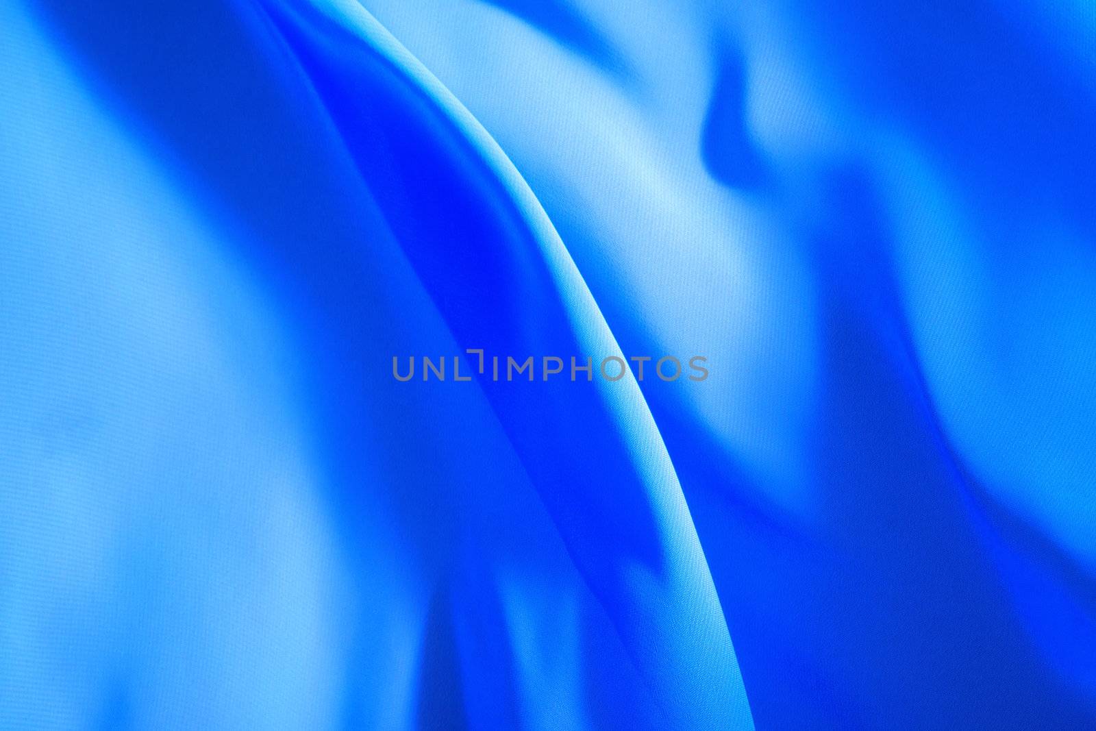 blue fabric winds waves, creating a beautiful background of the folds