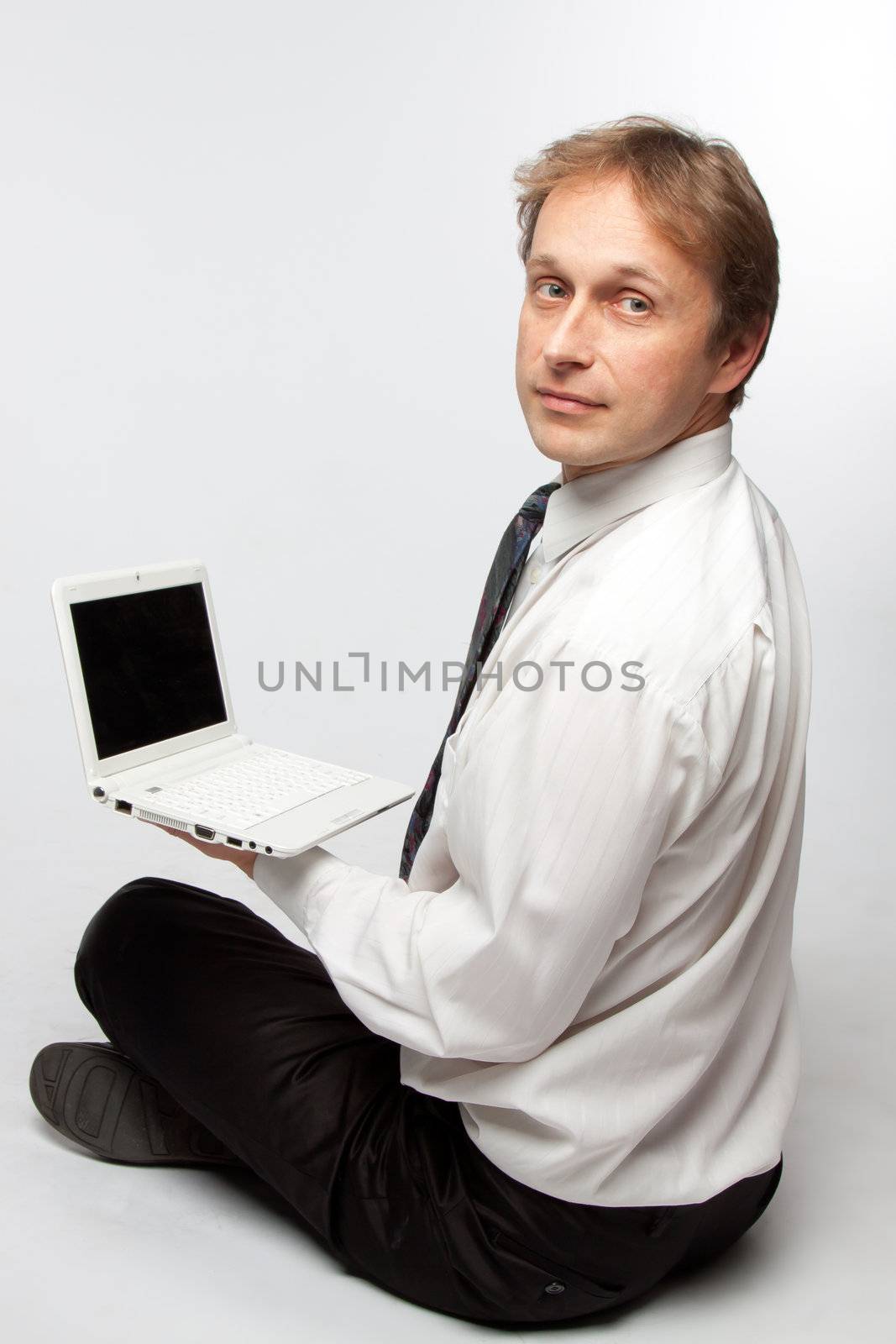 Portrait of middle-aged man with a white laptop computer