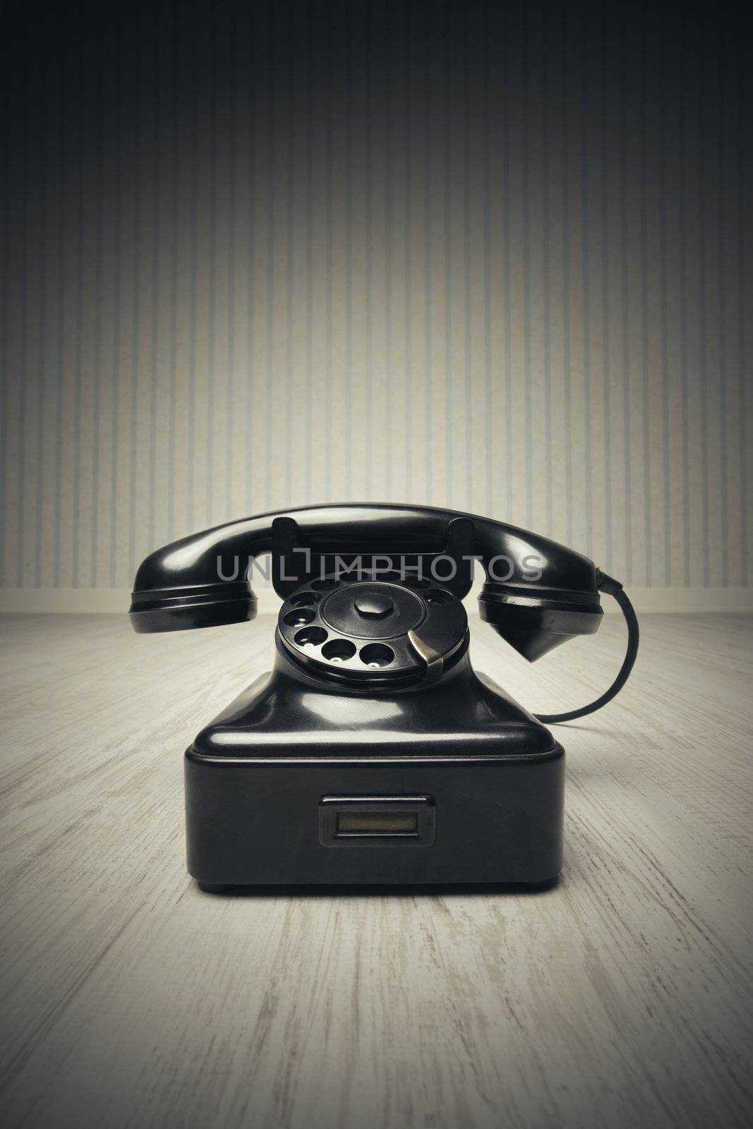 Old-fashioned phone on a wooden floor