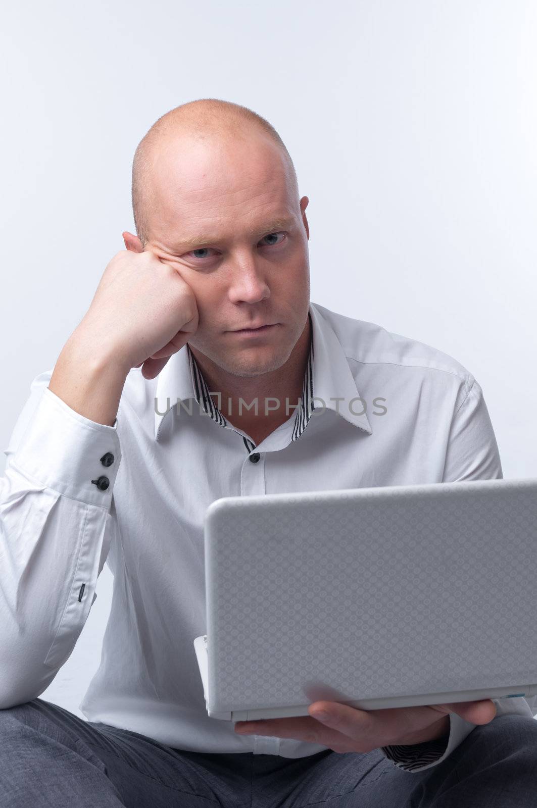 Portrait of middle-aged man with a white laptop computer