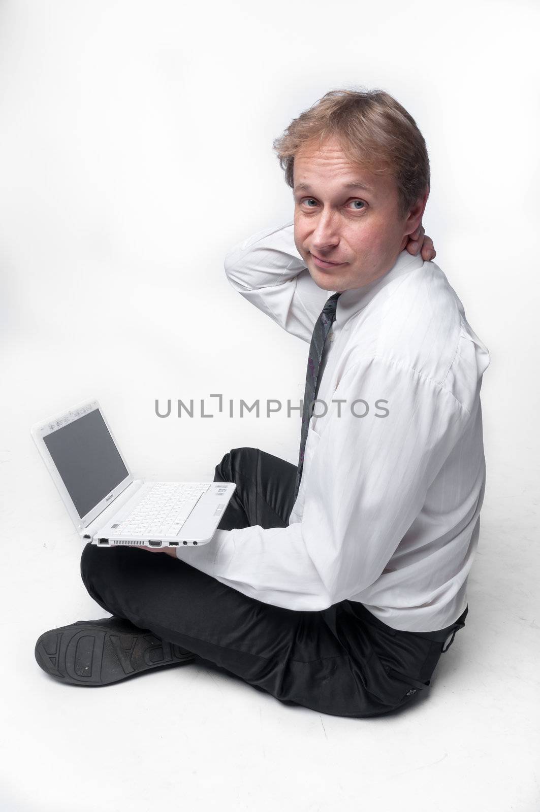 Portrait of middle-aged man with a white laptop computer