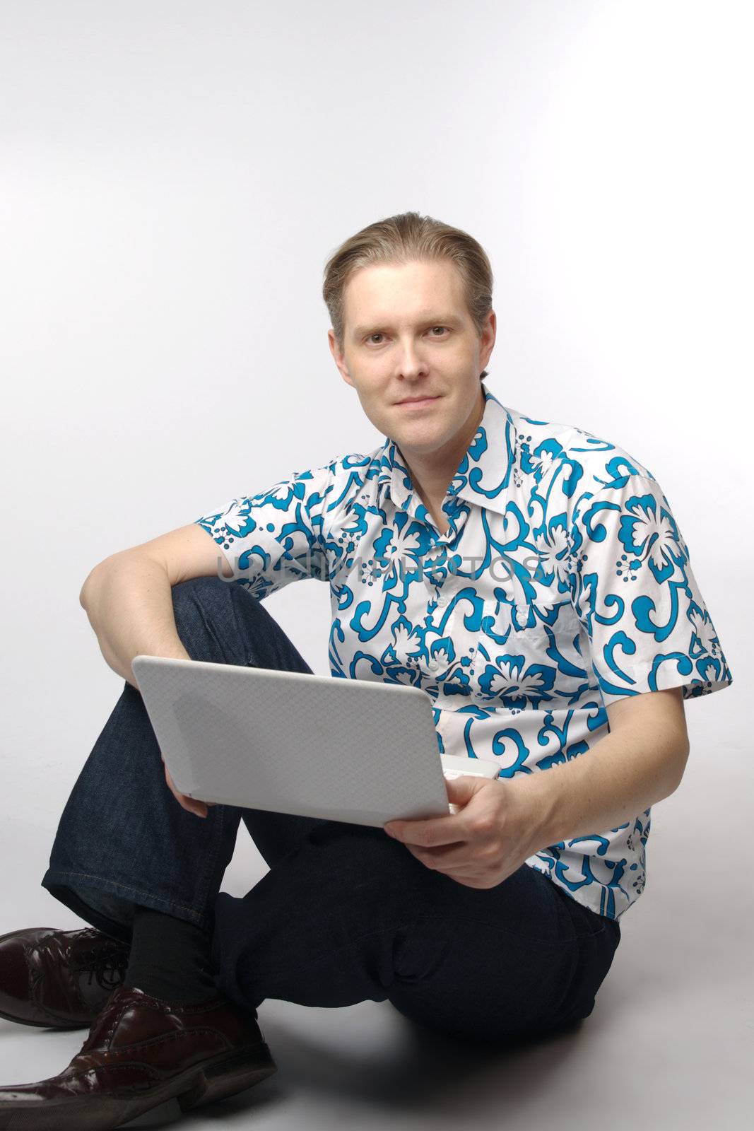 Portrait of middle-aged man with a white laptop computer