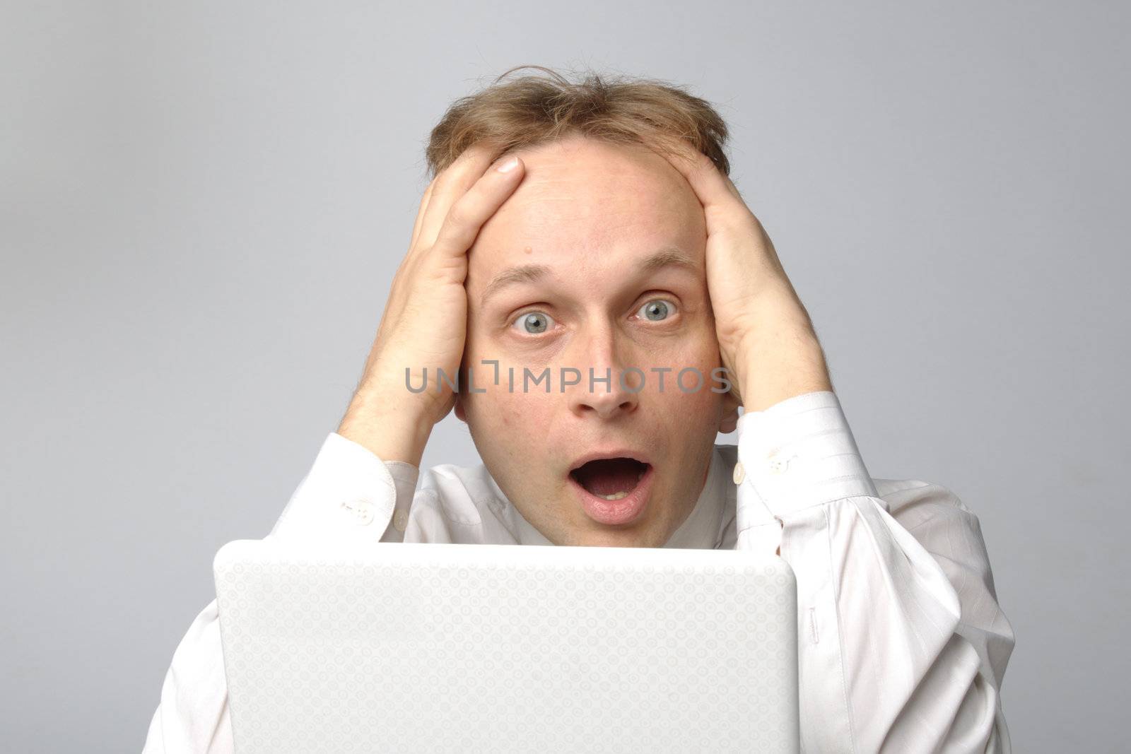 Portrait of middle-aged man with a white laptop computer