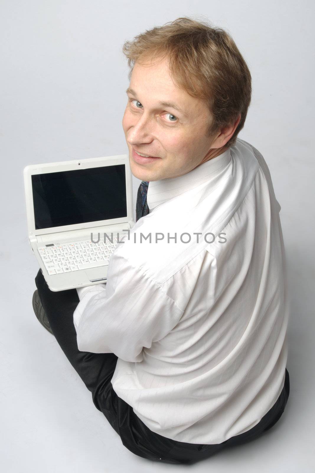 Portrait of middle-aged man with a white laptop computer