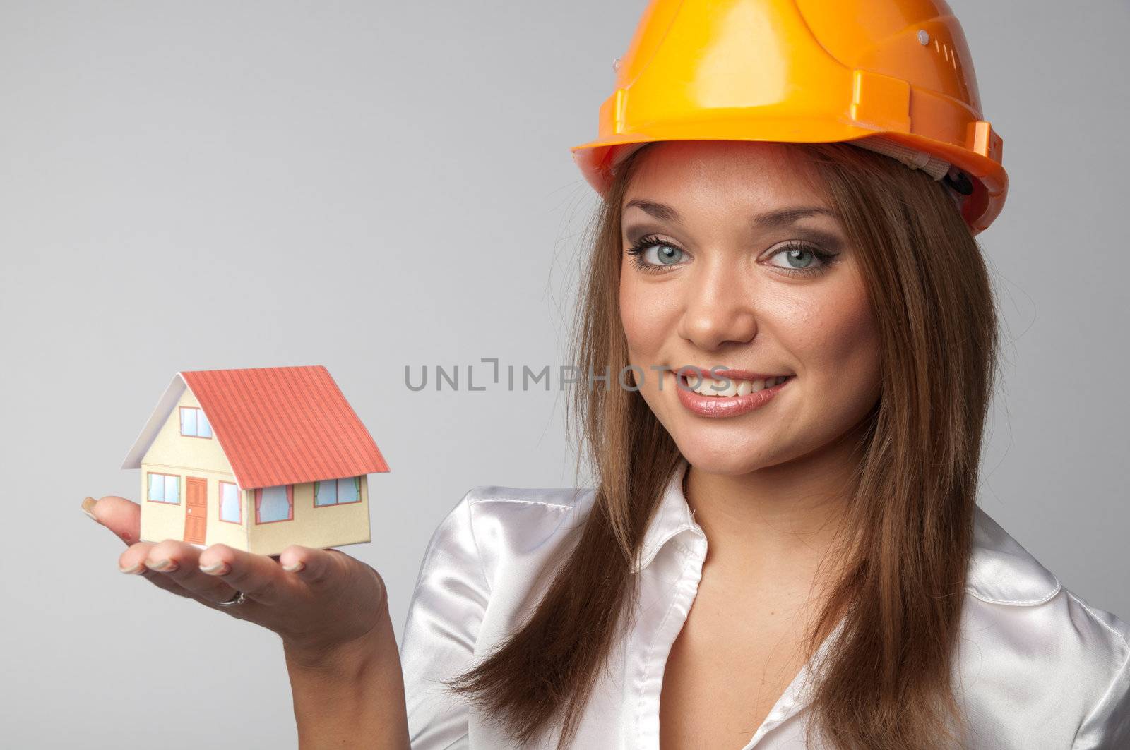 Little House in the hands of young and beautiful business woman