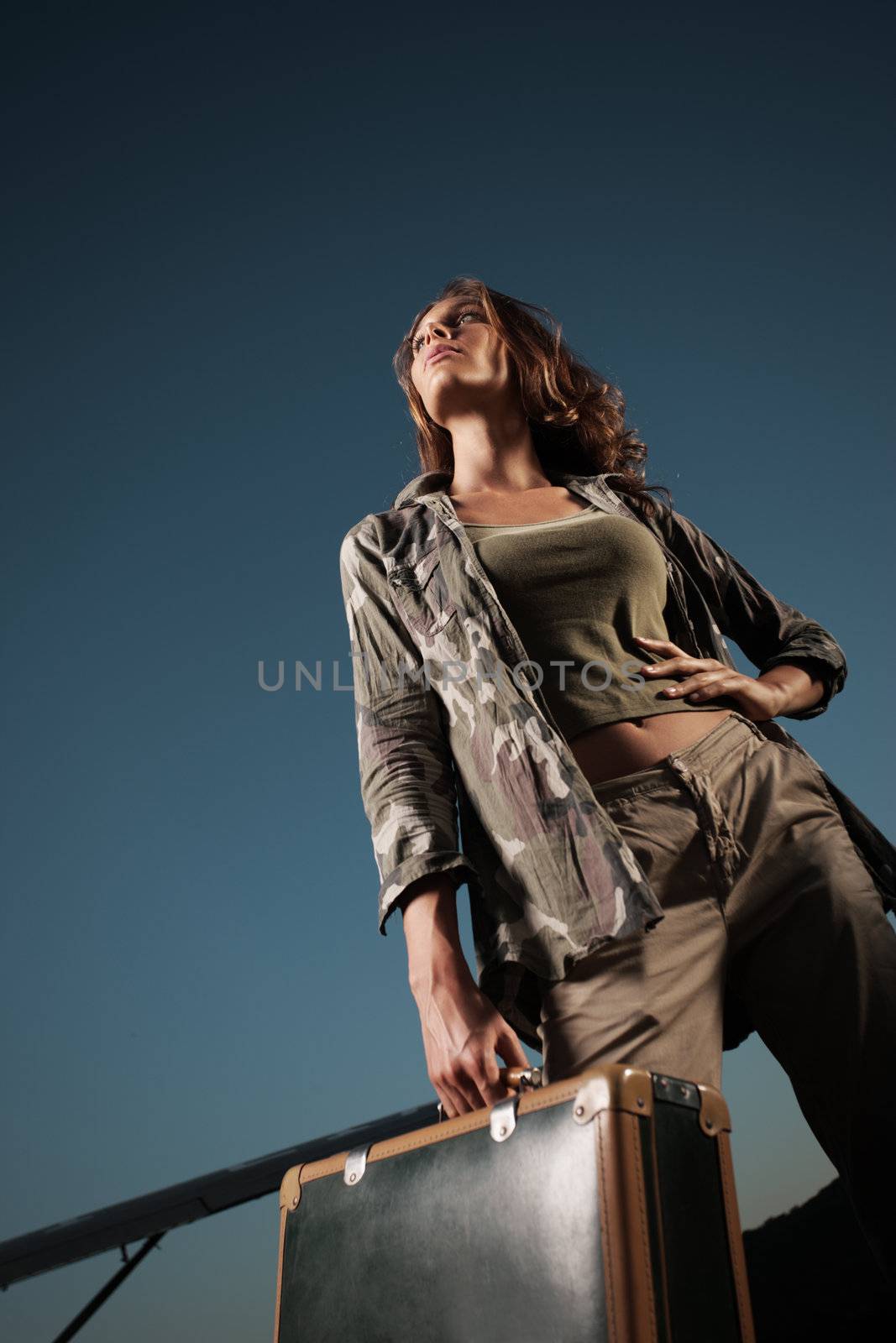Fashion  woman with a suitcase, ready to start.