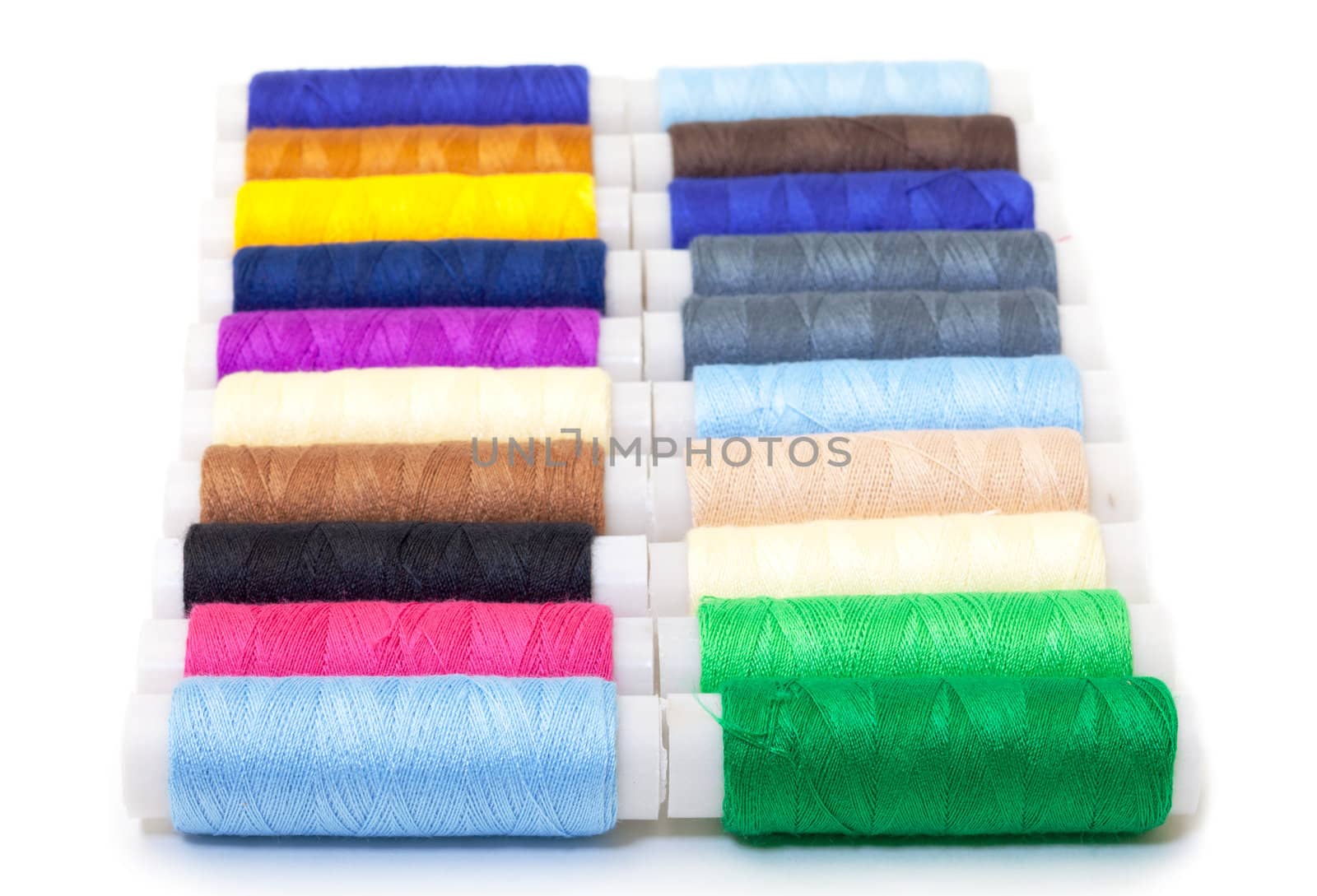 Several Multicolor Spools of Thread on white background