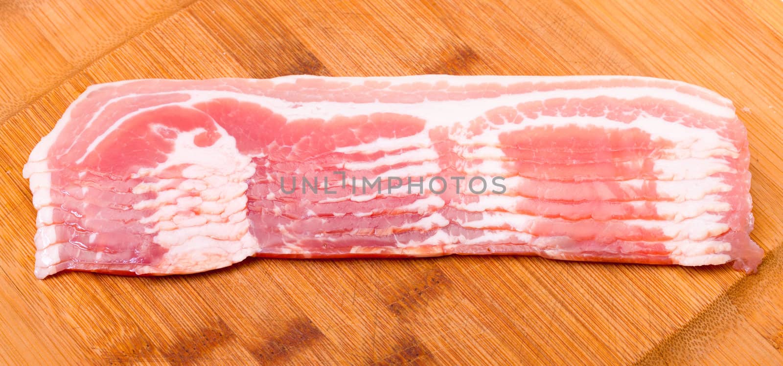 Fresh Sliced Bacon, on wood background