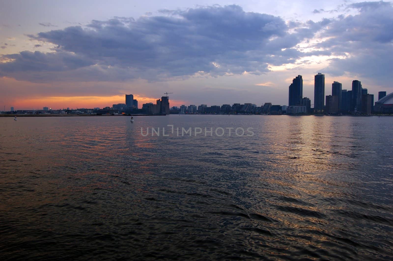 Toronto skyline from Ontario lake in time of sunset