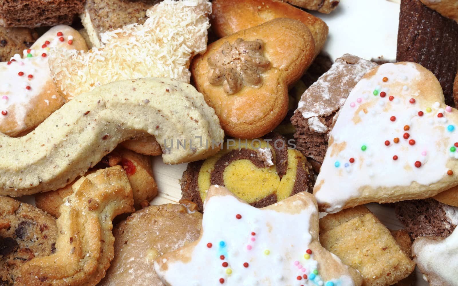 Close-up image of a stack of various biscuits and cookies.