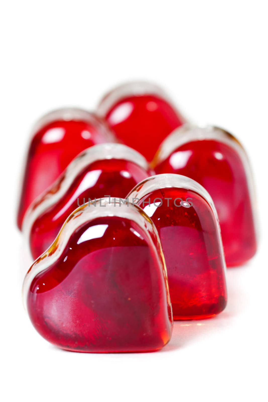 Red heart shaped gems on white background