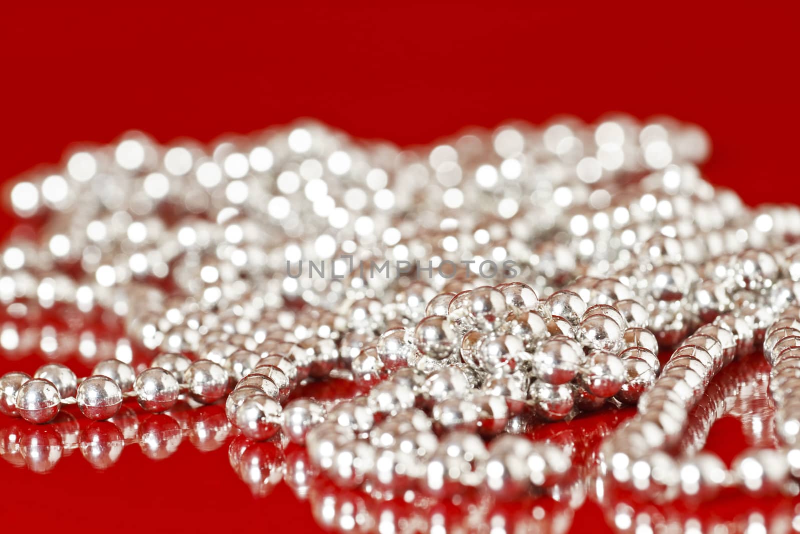 Shiny Silver Pearls on red background