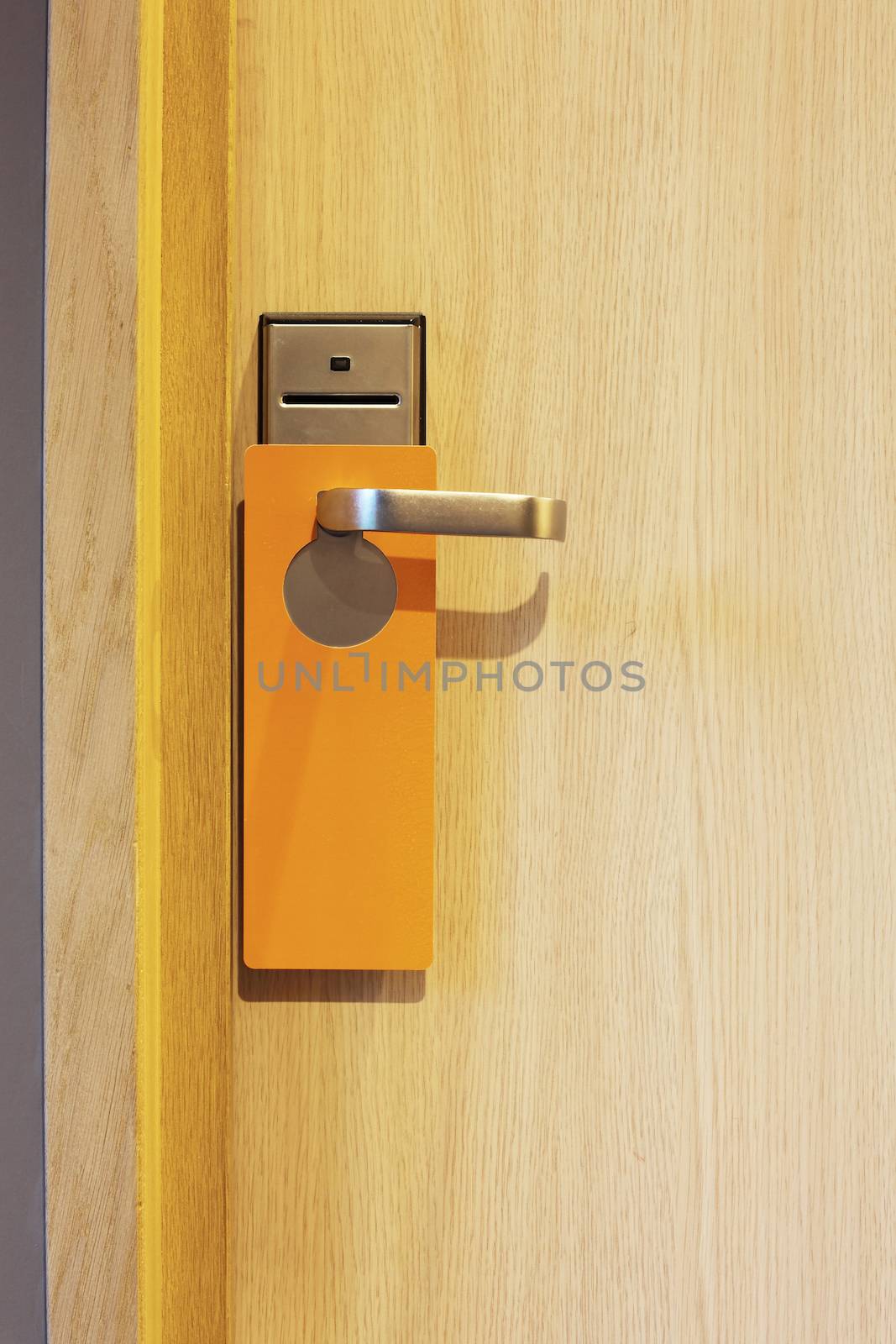 hotel door with orange card to avoid disturbing