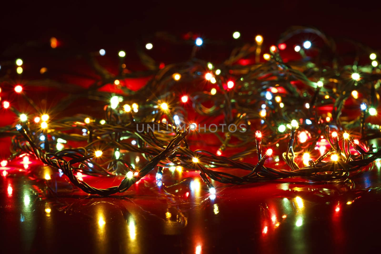 Dimmed Christmas Lights on deep red background