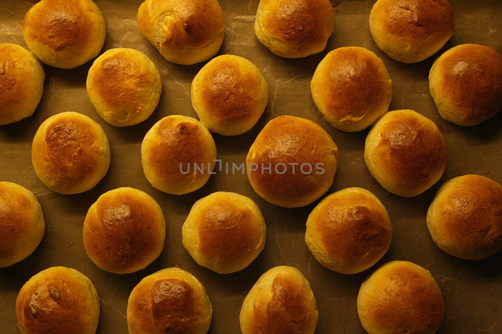 Golden wheat buns freshly baked, straight from the oven