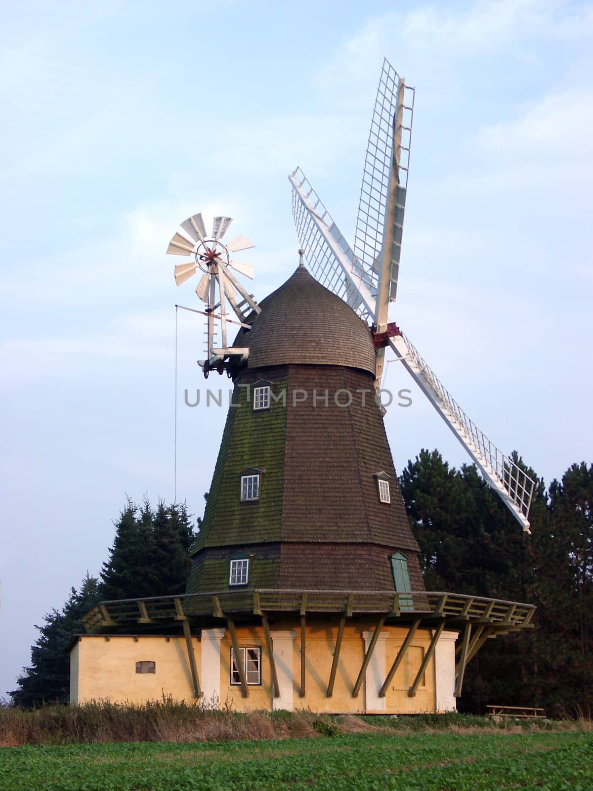 Evening view of old Danish windmill with the secondary turning drive and brick basement.