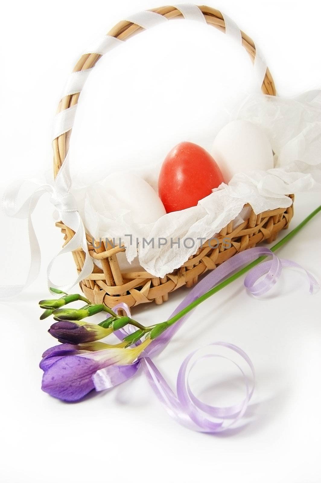 Basket with white and red eggs isolated on white