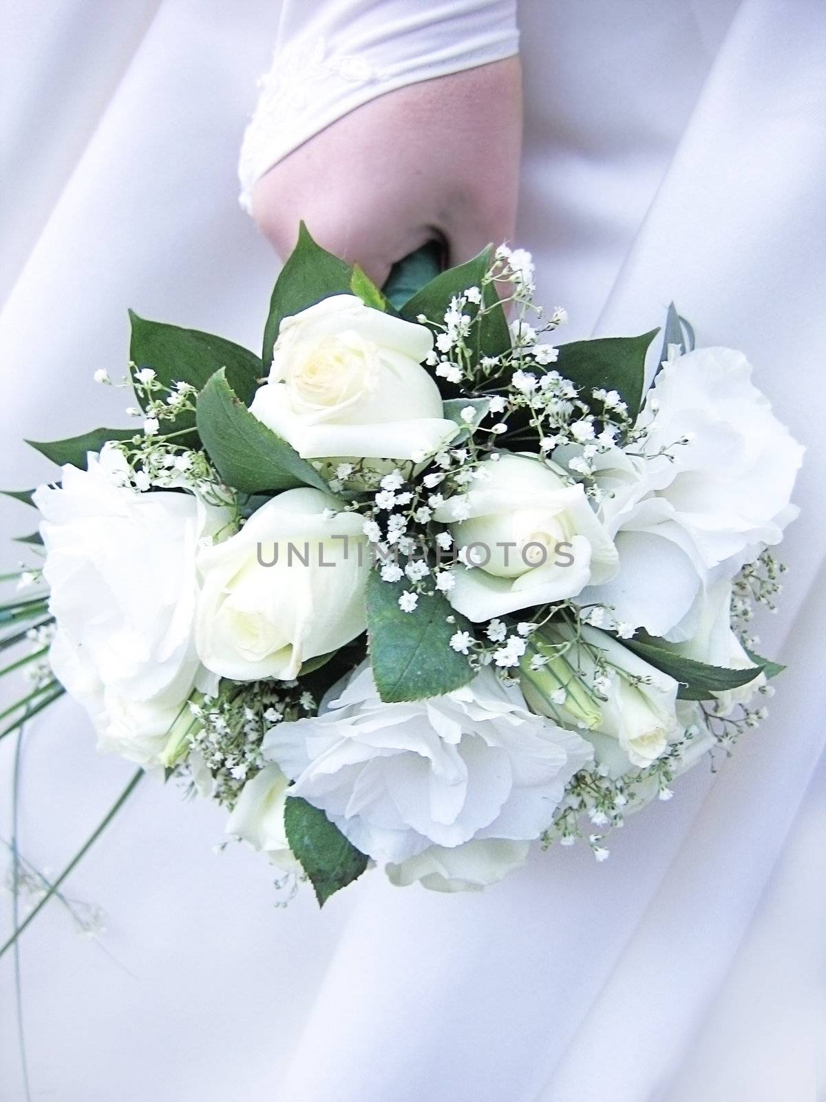 Bride's hand holding wedding bouquet