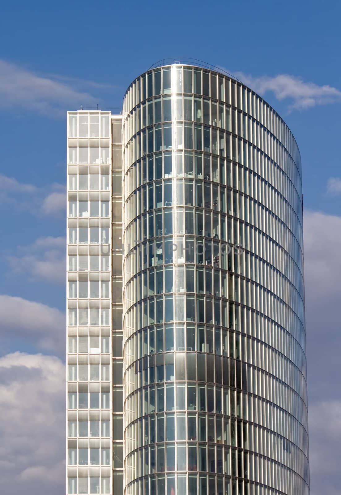 Shiny, modern office building against nice blue sky