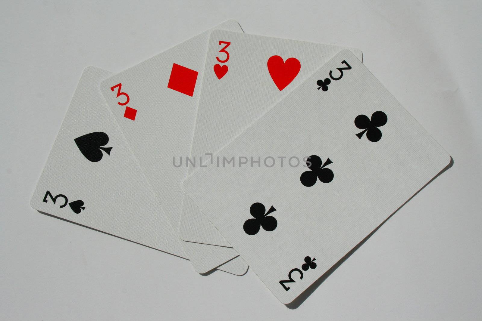 Close up of four threes on a white background.
