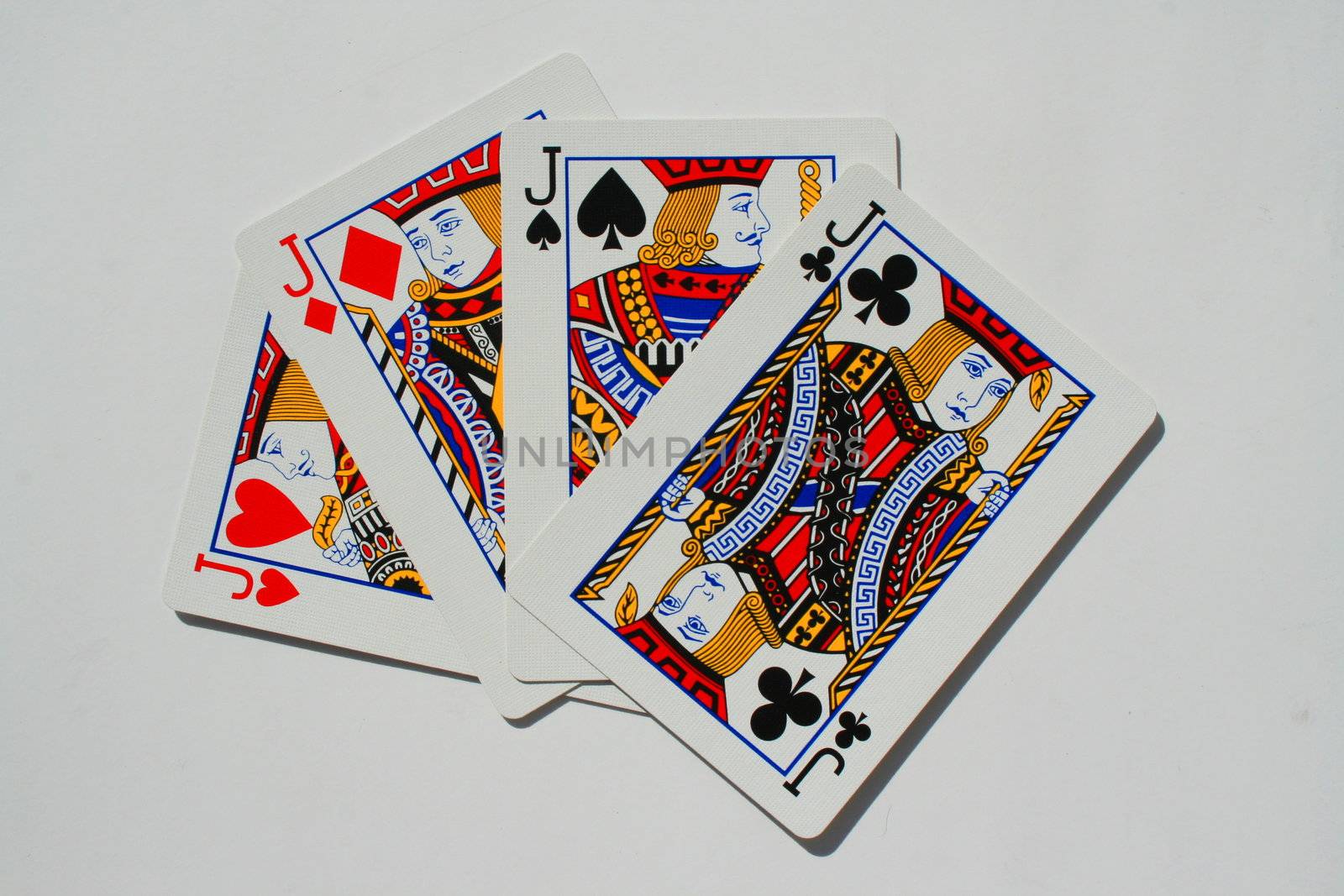 Close up of four jokers on a white background.
