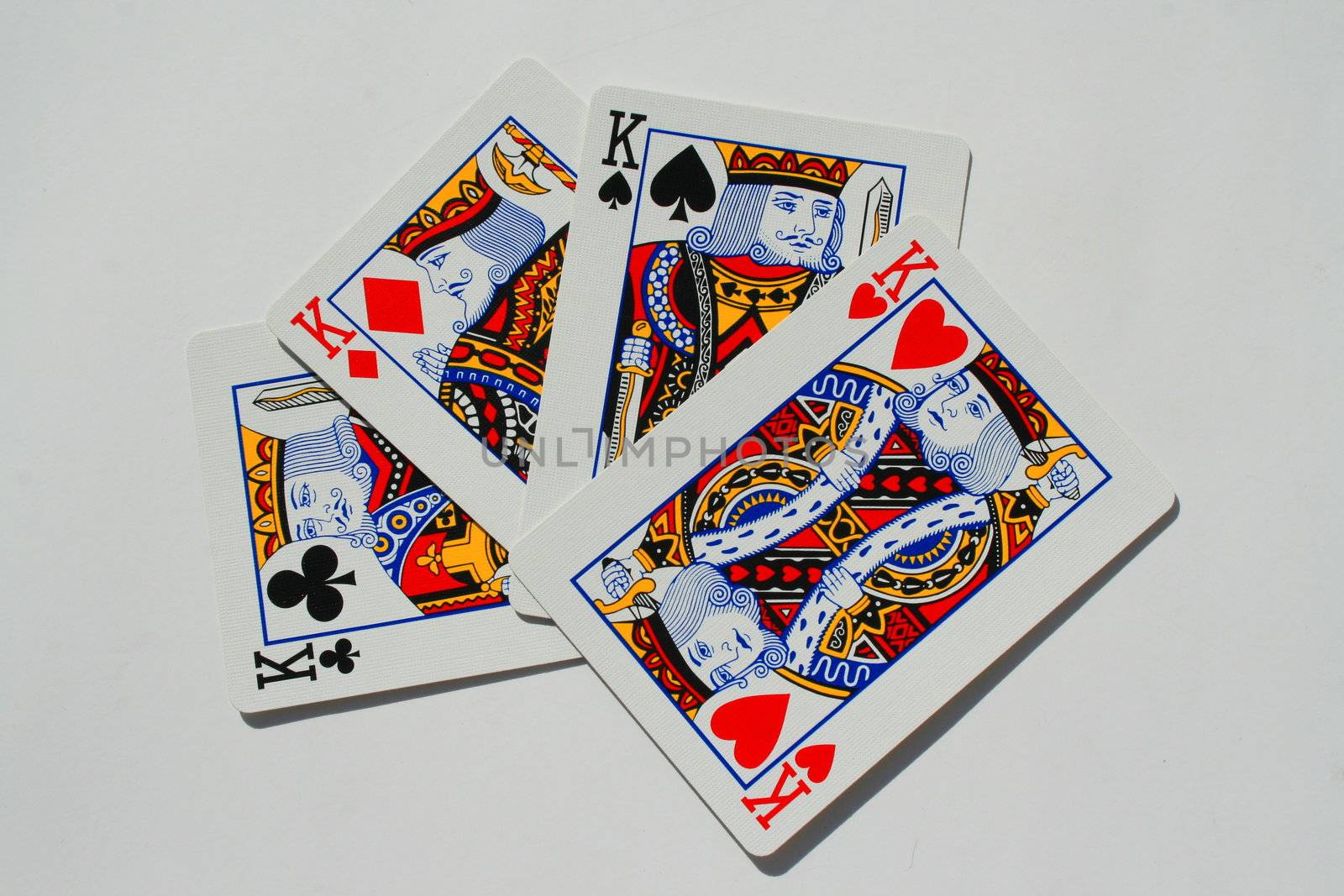 Close up of four kings on a white background.
