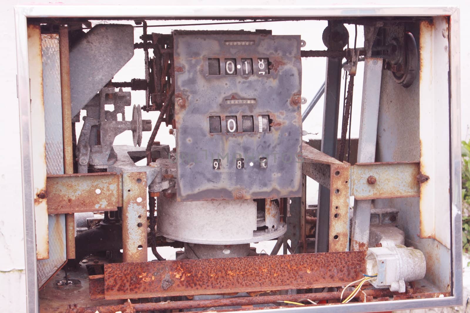 the front of an old fuel pump showing the workings